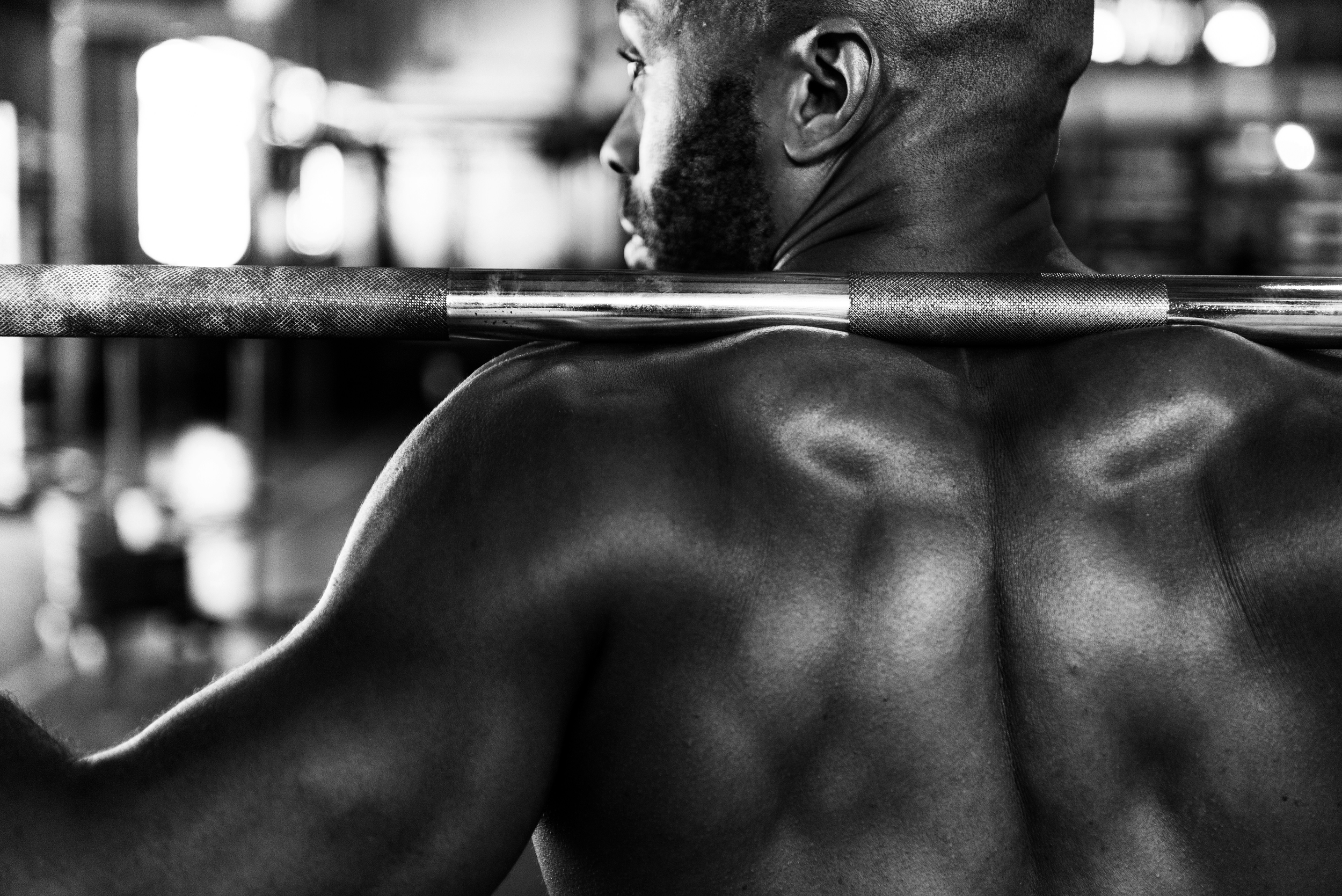 Man training with barbell in gym, representing real coaching, accountability, and results