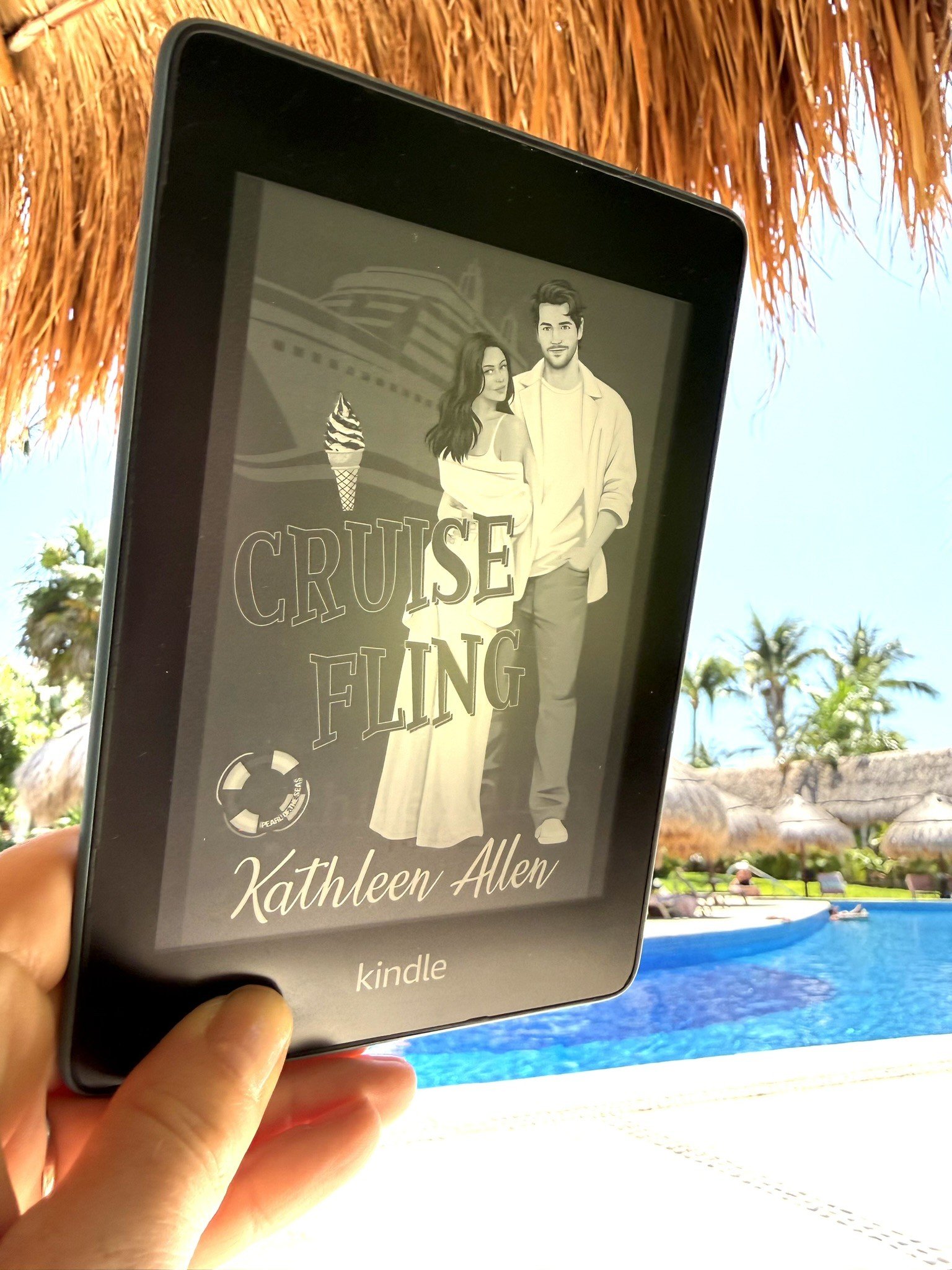 Reading Cruise Fling by Kathleen Allen on a Kindle poolside at a tropical resort — book two in the Pinnacle Cruise Line series, a vacation romance novel perfect for beach and pool reads