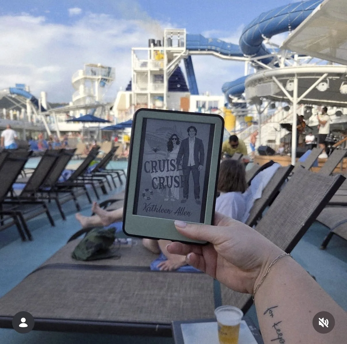 A person holding a digital e-reader displaying the book cover of 'Cruise Crush' by Kathleen Allen, with a cruise ship pool area and people relaxing on lounge chairs in the background.