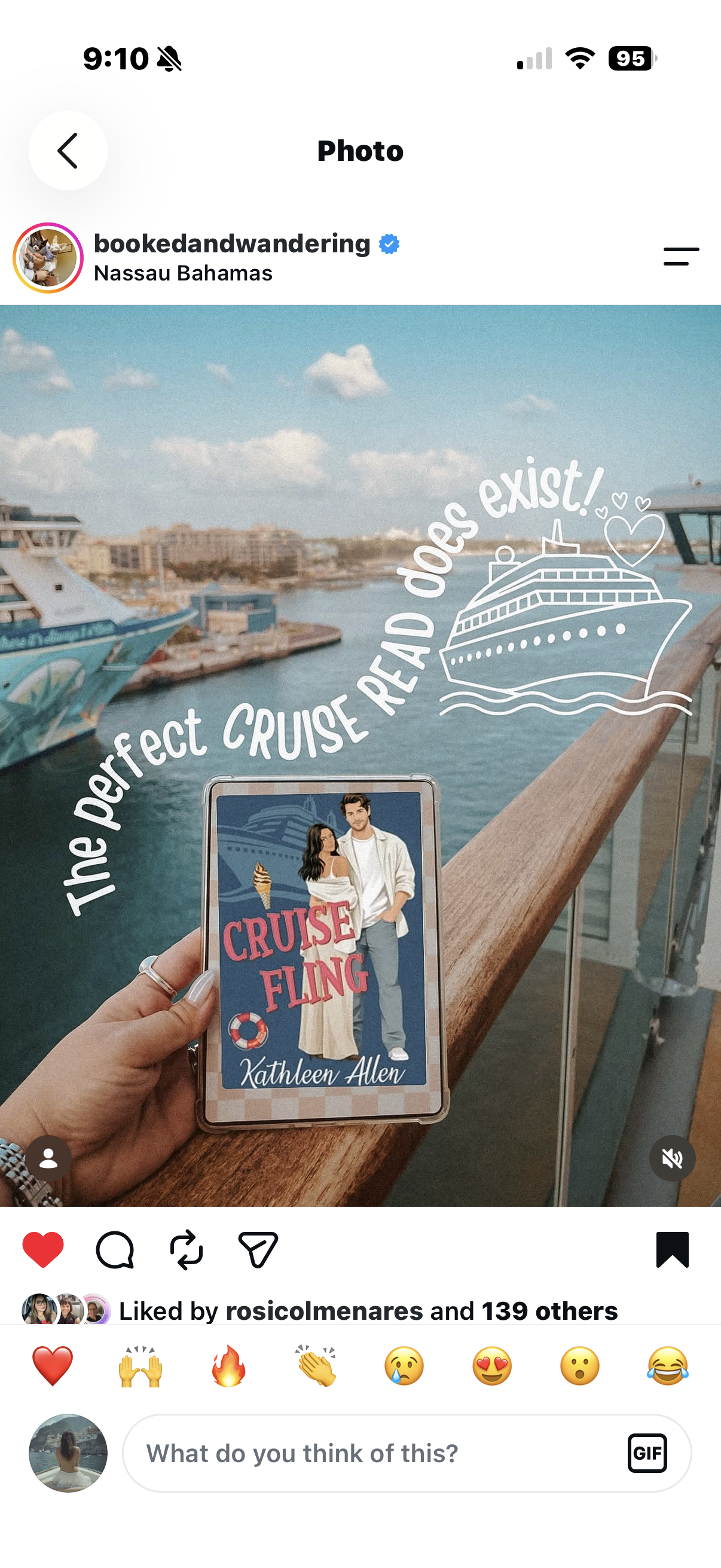 A person holding a cruise ship-themed card titled 'Cruise Fling' with a couple illustrated on it, standing at a balcony overlooking a harbor with cruise ships and city buildings in Nassau, Bahamas. White text curves around a simple line drawing of a cruise ship, saying 'The perfect cruise read does exist!'