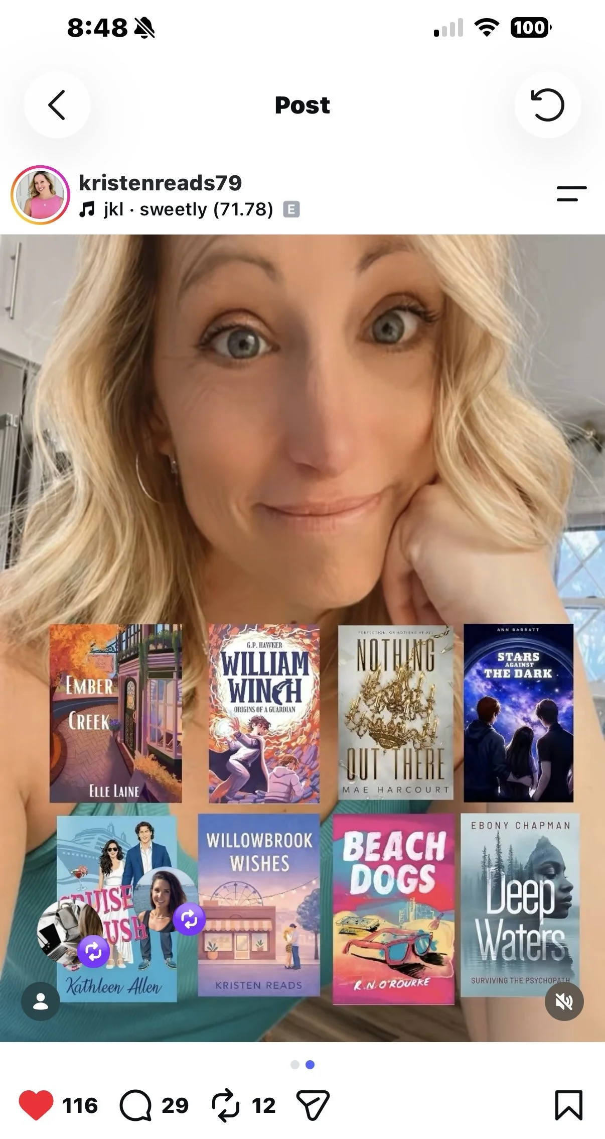 A woman with blonde hair smiling at the camera, holding a phone with a display of various book covers.