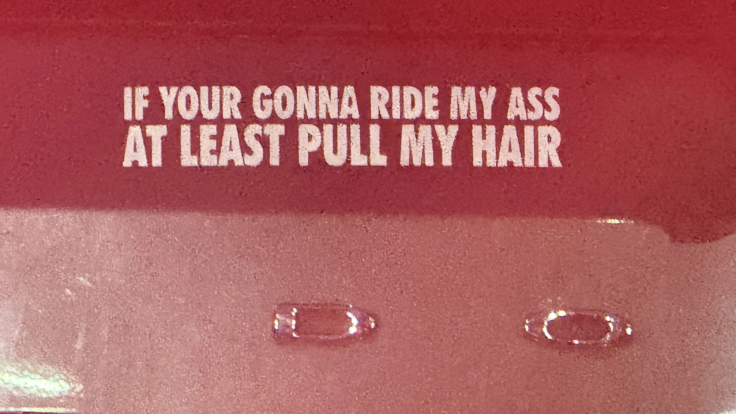 Red background with a humorous message in white text: 'If you're gonna ride my ass at least pull my hair.'
