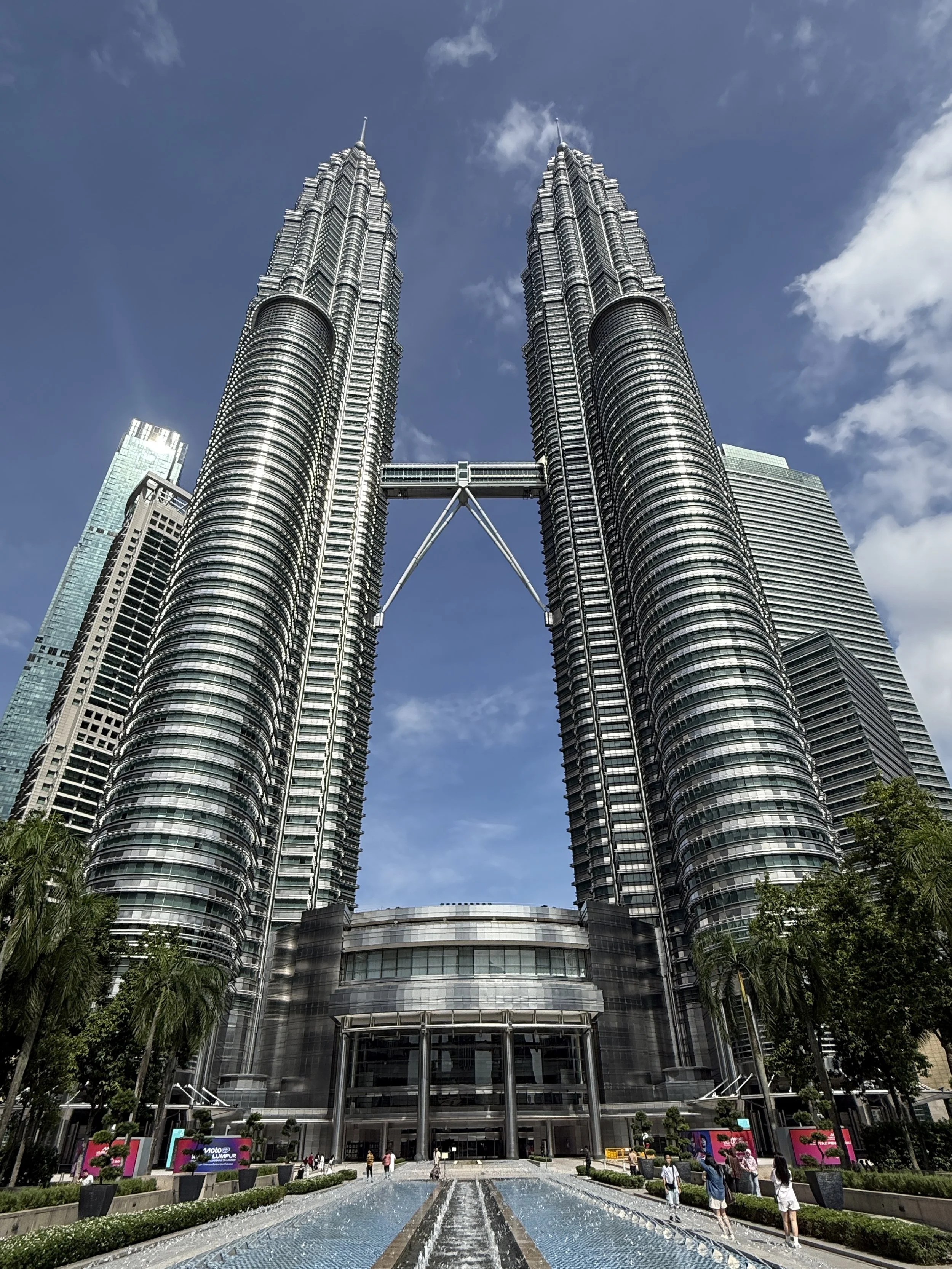 The Petronas Twin Towers in Kuala Lumpur, Malaysia, with a reflective fountain.
