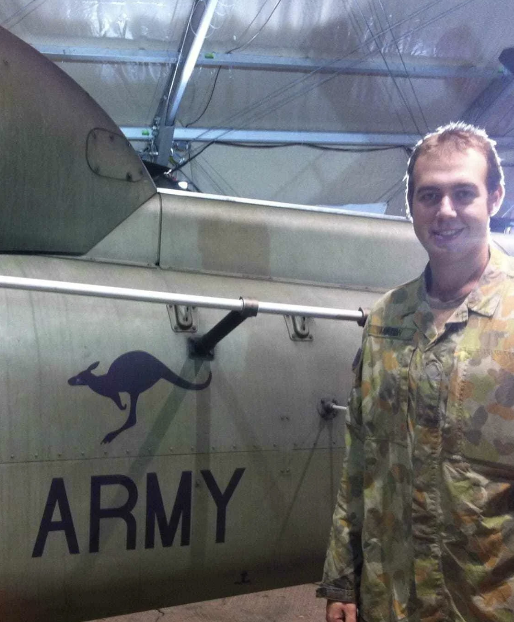 Australian Army veteran in uniform beside an Army helicopter, representing the ADF service history TAG Legal helps convert into DVA compensation