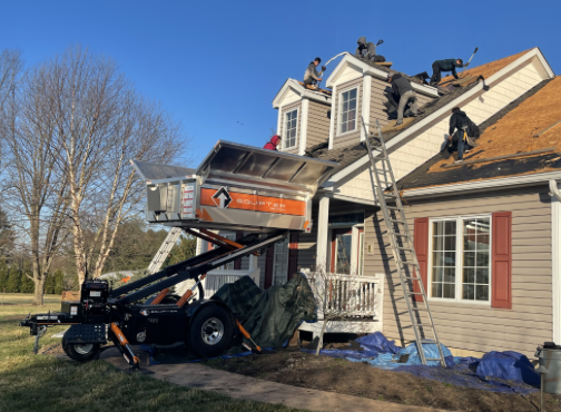 Roofing crew installing a new roof on a residential home