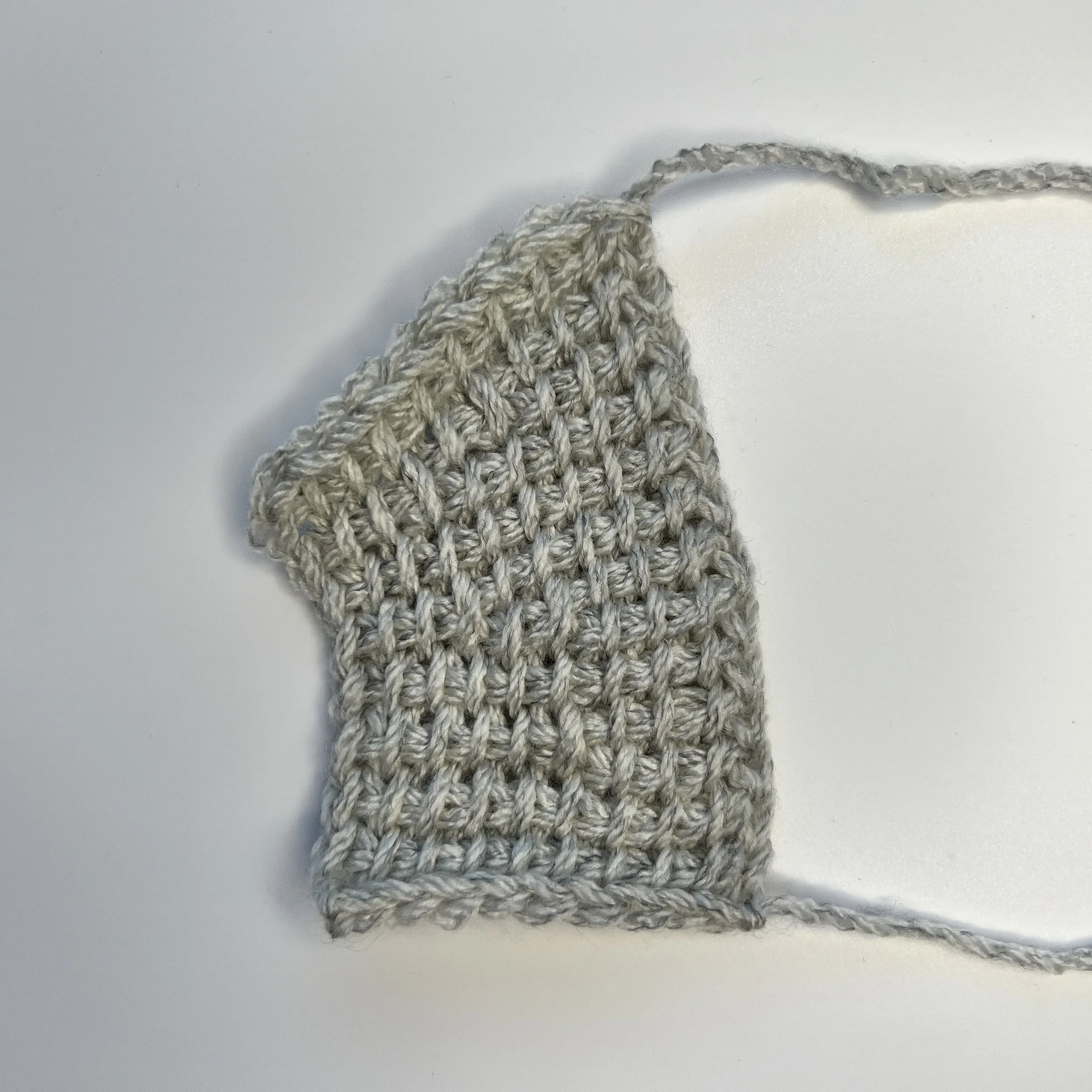 2nd row above short row: Worked as a row of tss except when you get to the twisted/crossed stitch, insert the hook under both loops of that stitch and treat those loops as one tss.