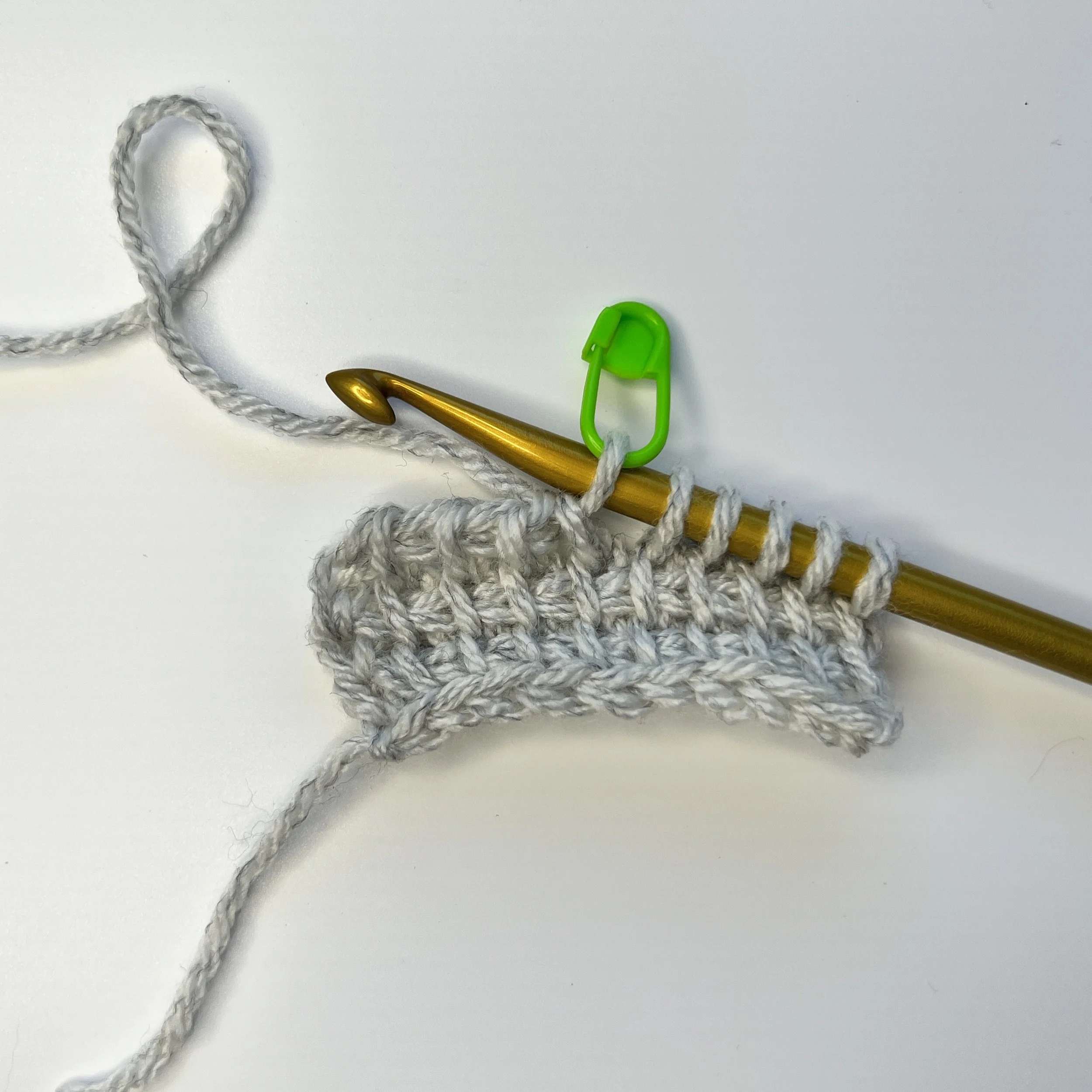 Short Row RP: Ch 1, *yarn over, pull through 2 loops* 4 times – 6 loops remain on hook. Place a marker in the 1st loop on the hook (closest to the hook). The stitch directly under the marked st is the first edge st of the short row.