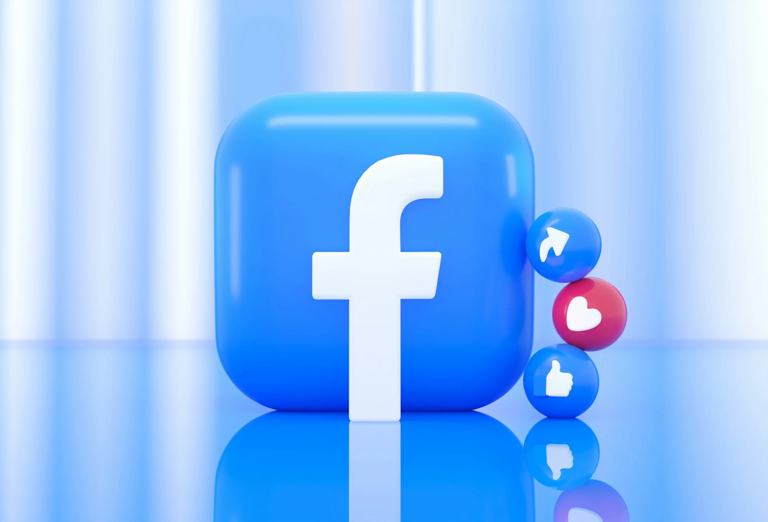 A large blue Facebook logo with smaller social media icons, including thumbs up and love reactions, surrounding it.