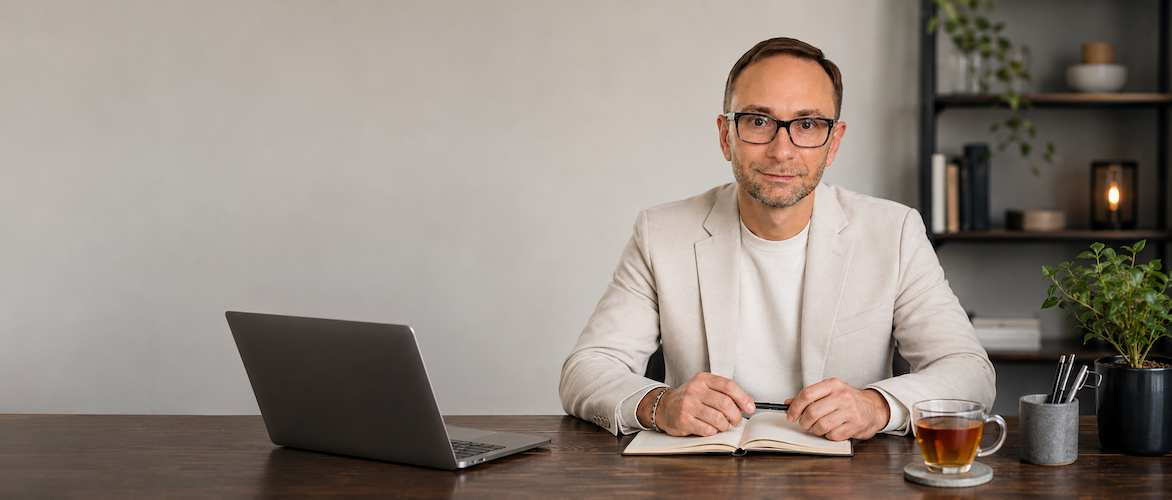 Alex Krasovsky in a calm coaching workspace helping clients find clarity with nutrition, wellness habits, and lasting lifestyle change.