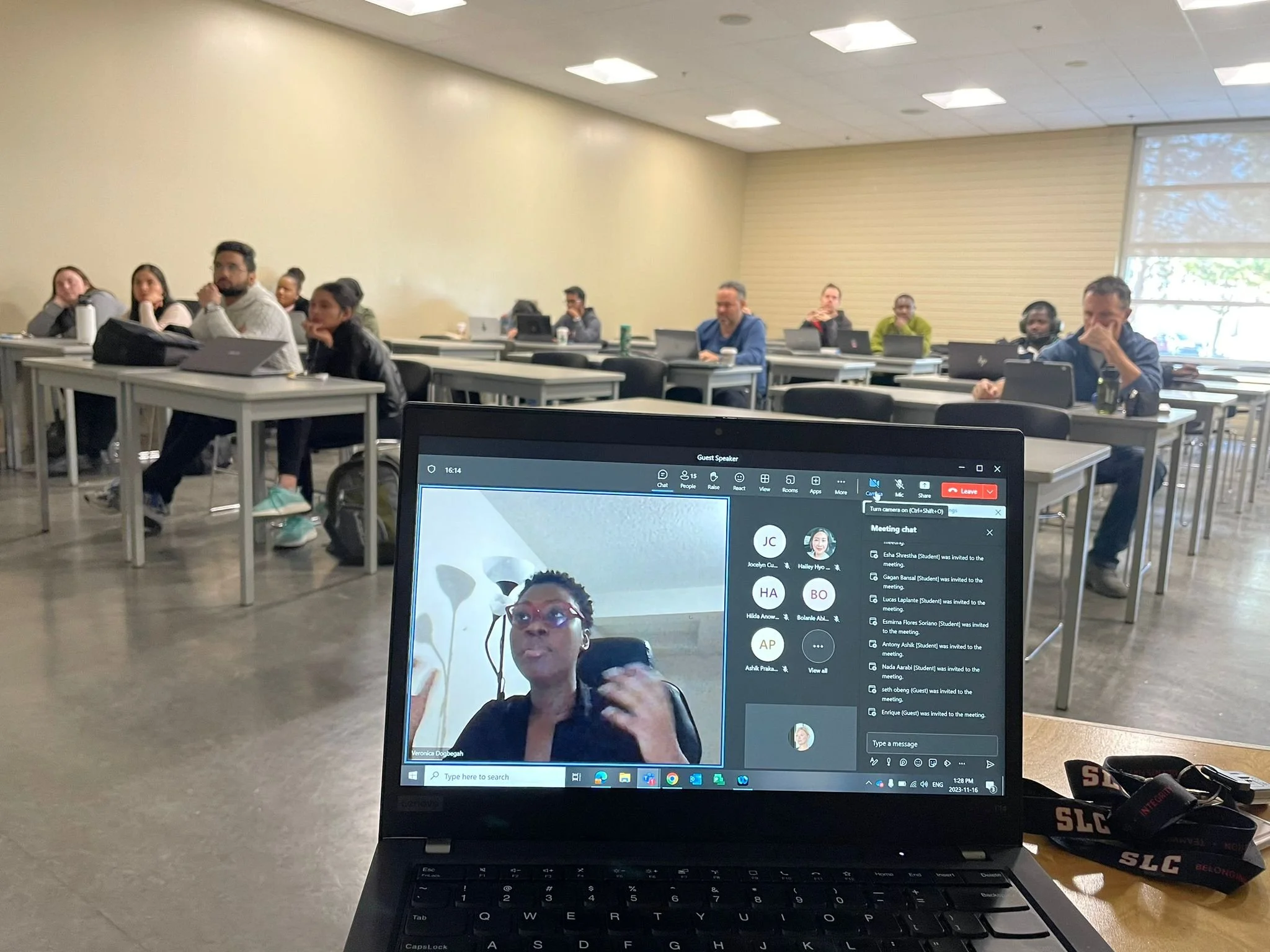 Veronica presenting at a workshop, with attendees viewing a laptop on a video call.