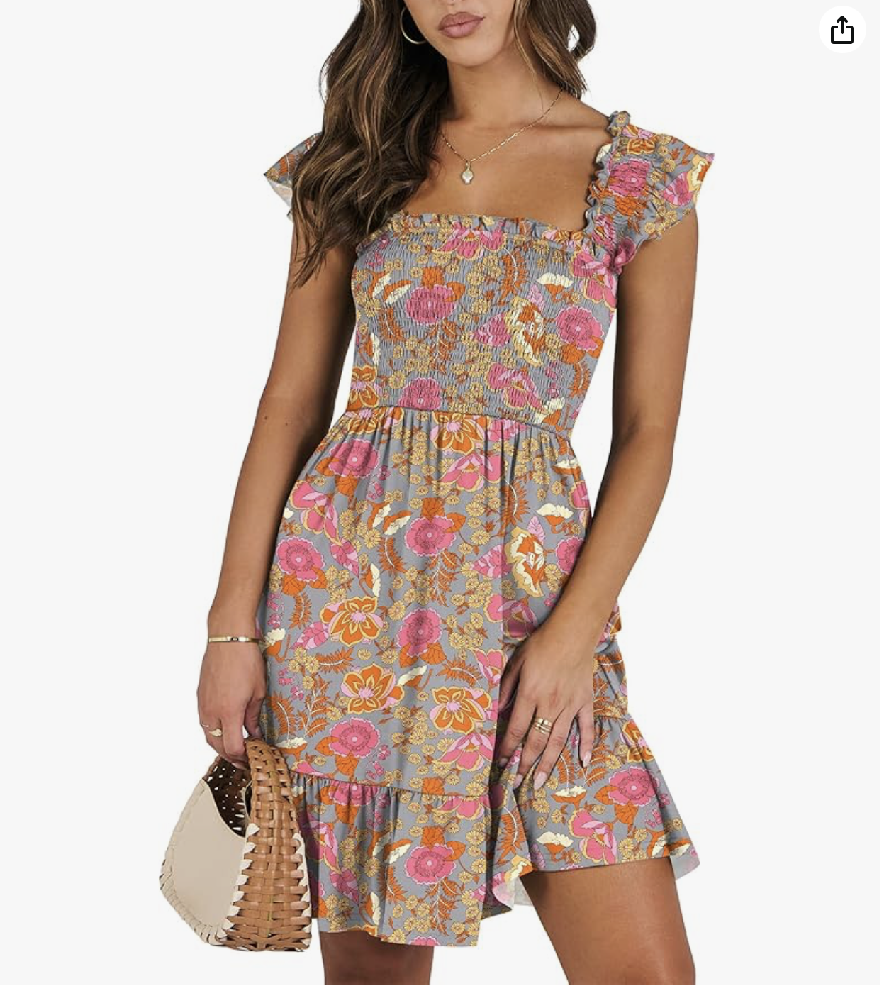 Woman wearing a floral dress with ruffled sleeves, holding a woven handbag.