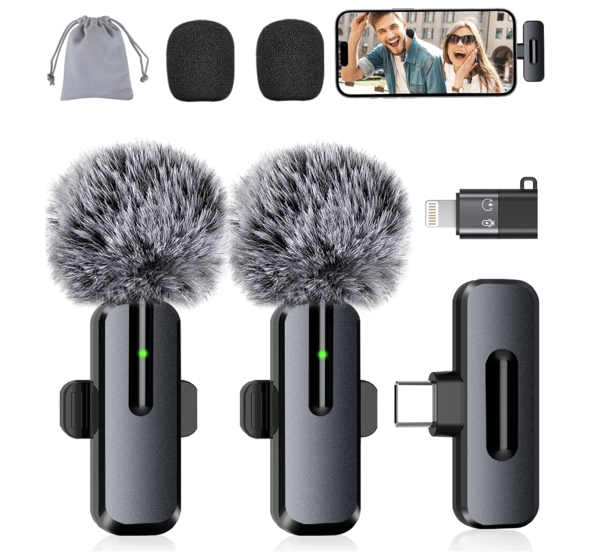 Two wireless microphones with furry windshields, a USB receiver, a charging dock, a USB flash drive, a smartphone showing a smiling man and woman, and a small drawstring pouch.