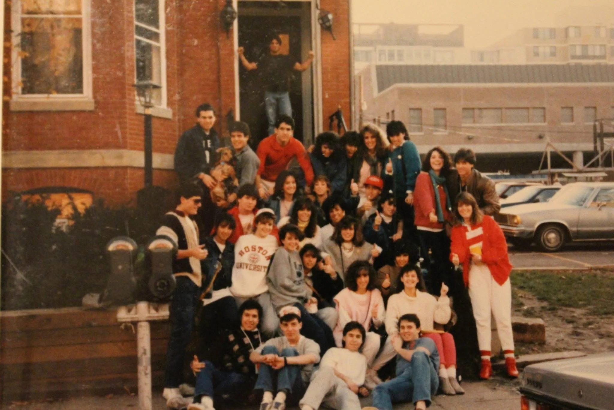A large group of fraternity brothers and friends outside our old chapter house.
