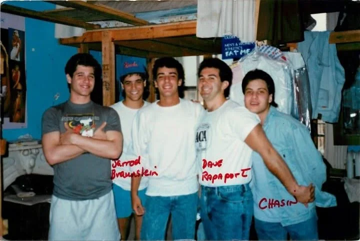 Five fraternity brothers standing beside each other.