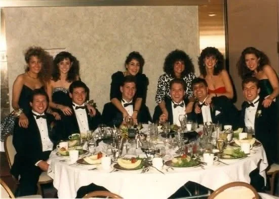 Fraternity brothers and dates enjoying formal.