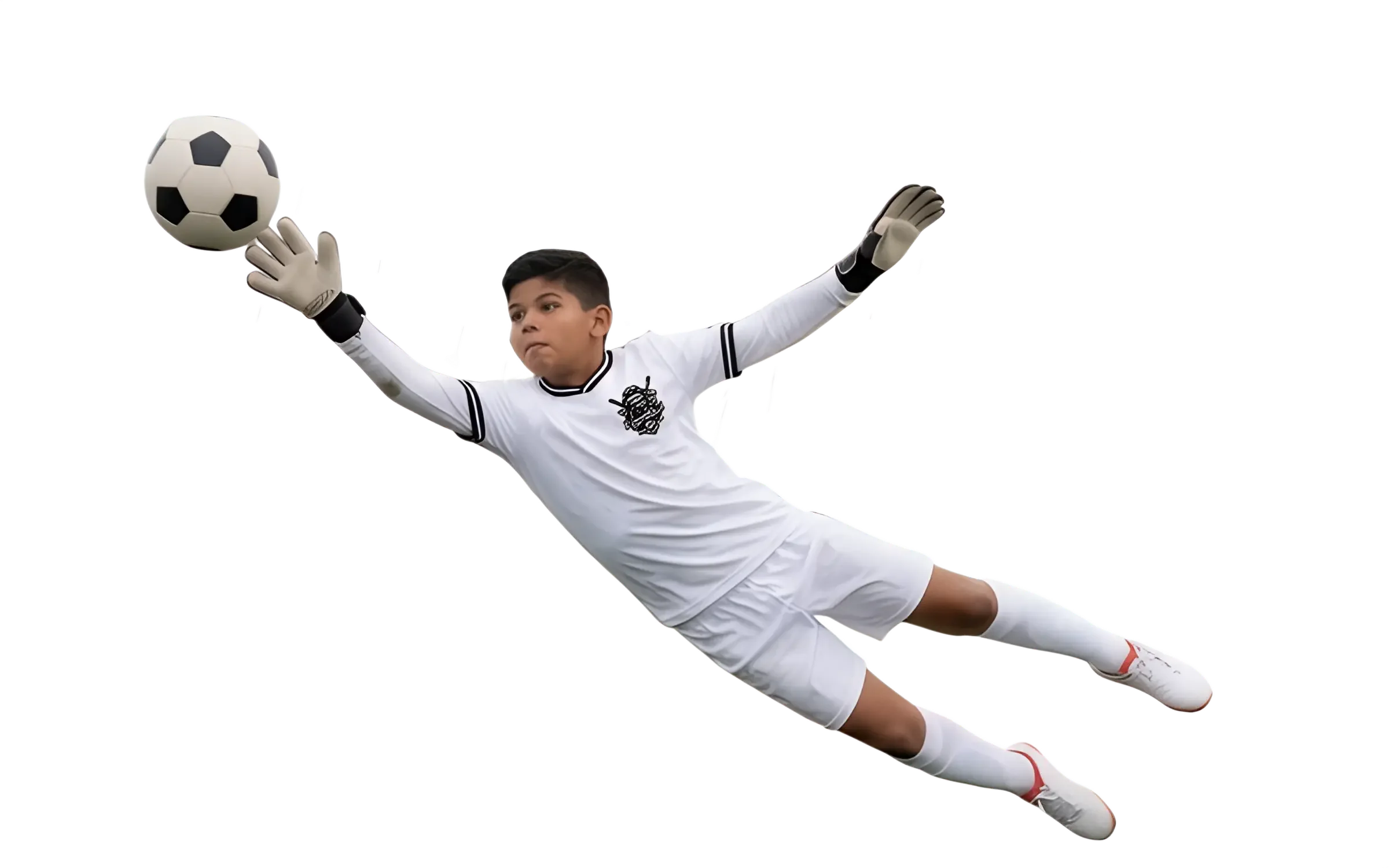 Young male soccer goalkeeper in white uniform diving to his left while reaching out with both hands to catch a soccer ball, wearing gloves and white cleats.