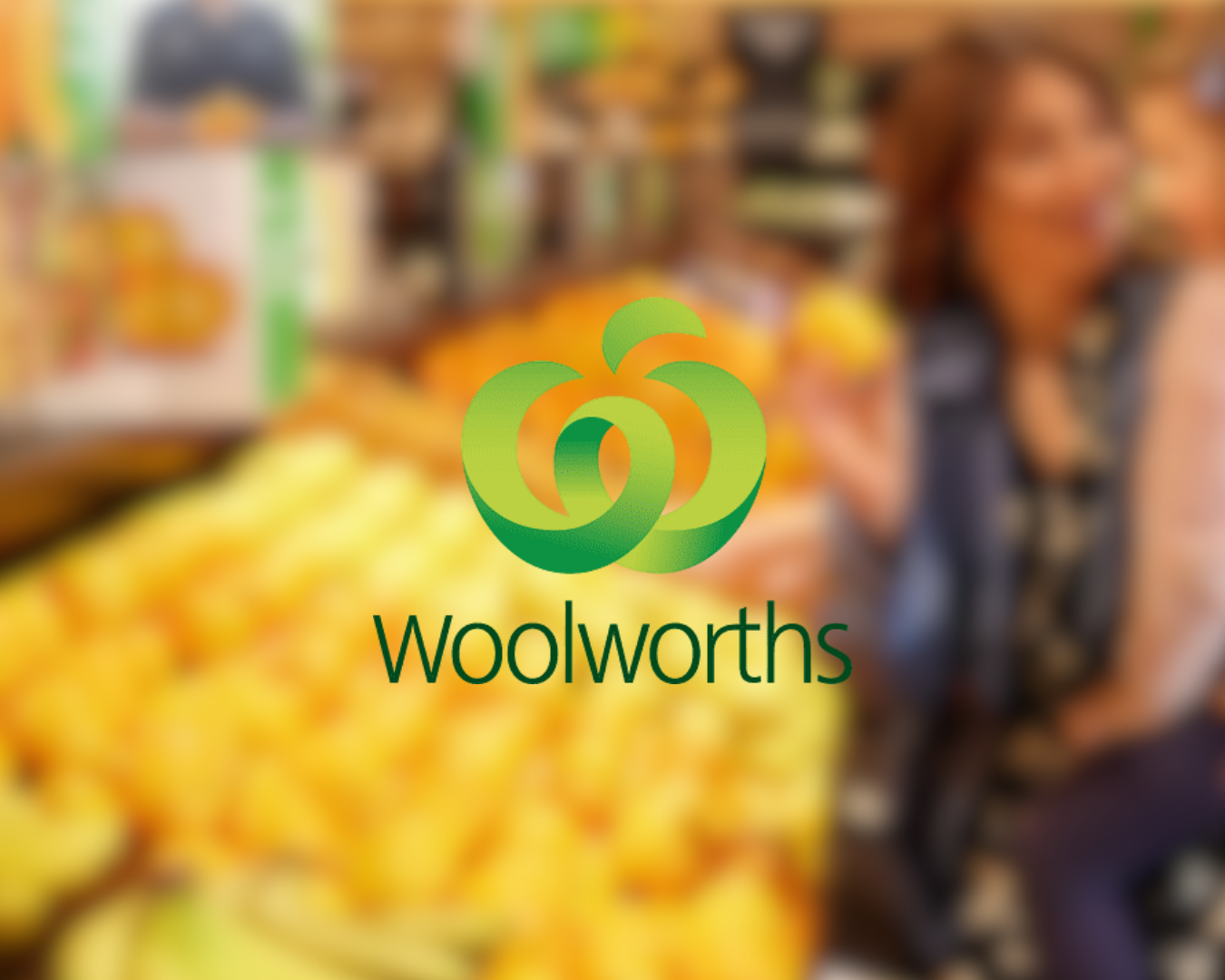 Blurred image of a grocery store produce section with yellow fruits, people shopping, and the Woolworths logo overlay.
