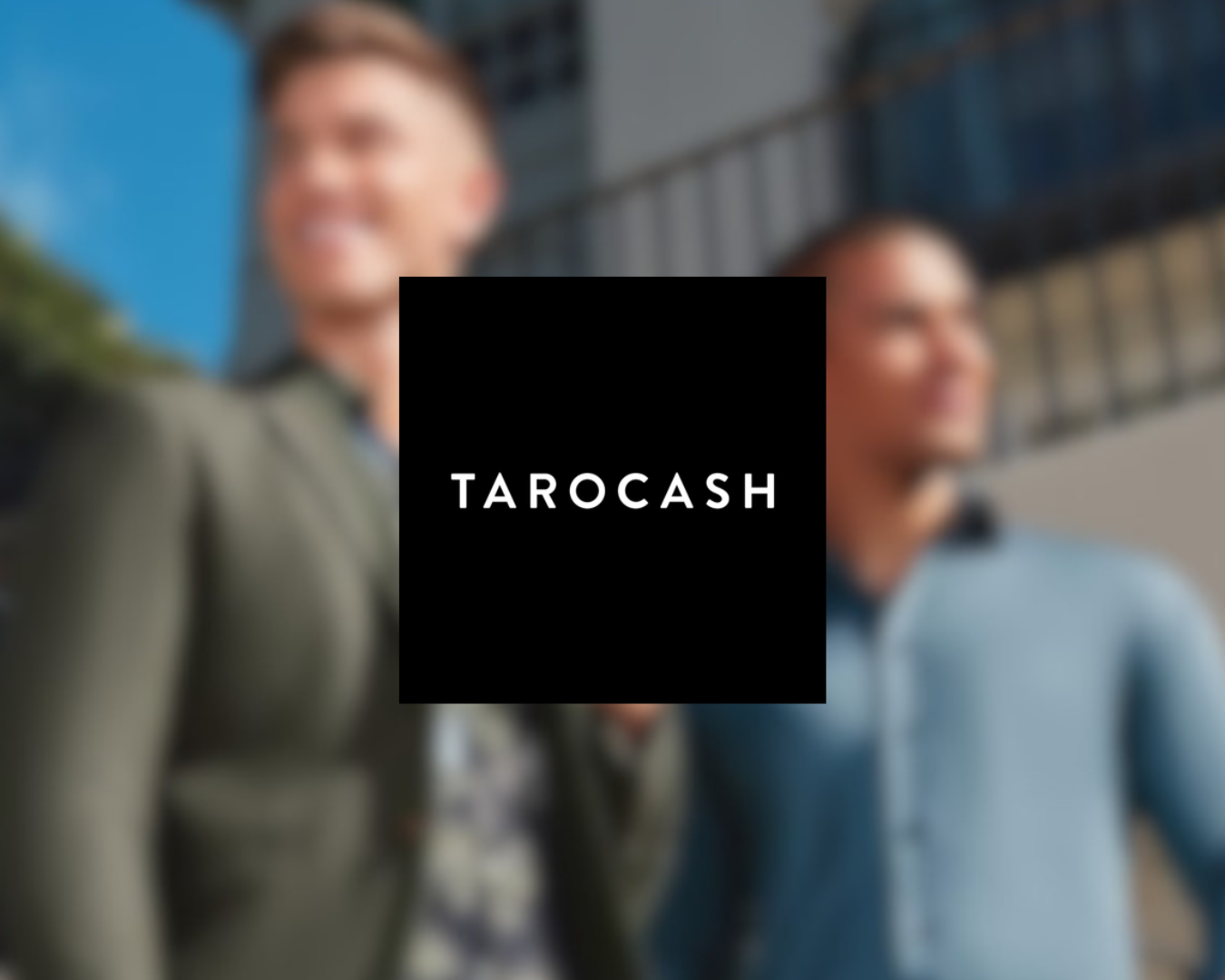 Two men standing outdoors in front of a building, smiling, with a black square overlay containing the text 'TAROCASH' in white.