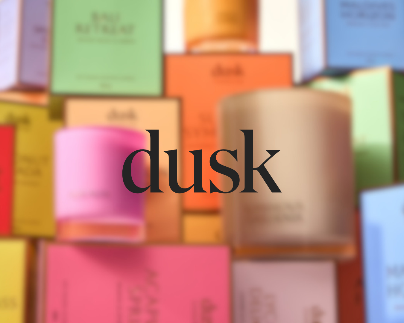 The image shows various colorful boxes and bottles, with the word 'dusk' written in large black letters across the center.