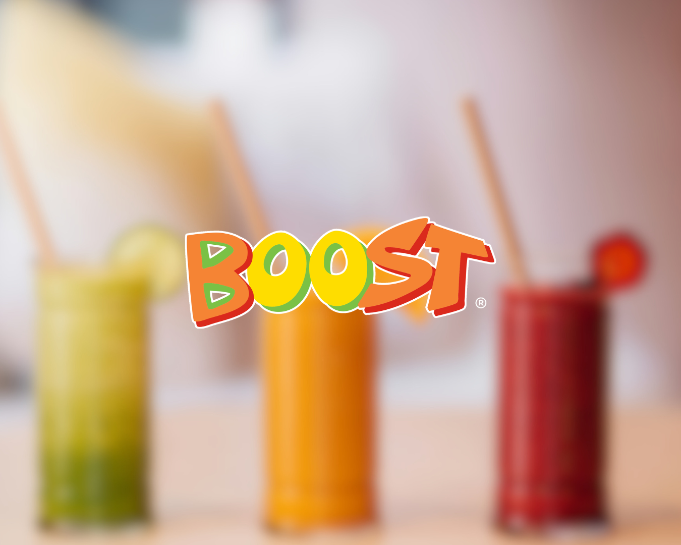Colorful smoothies in three glasses with the Boost logo in front.