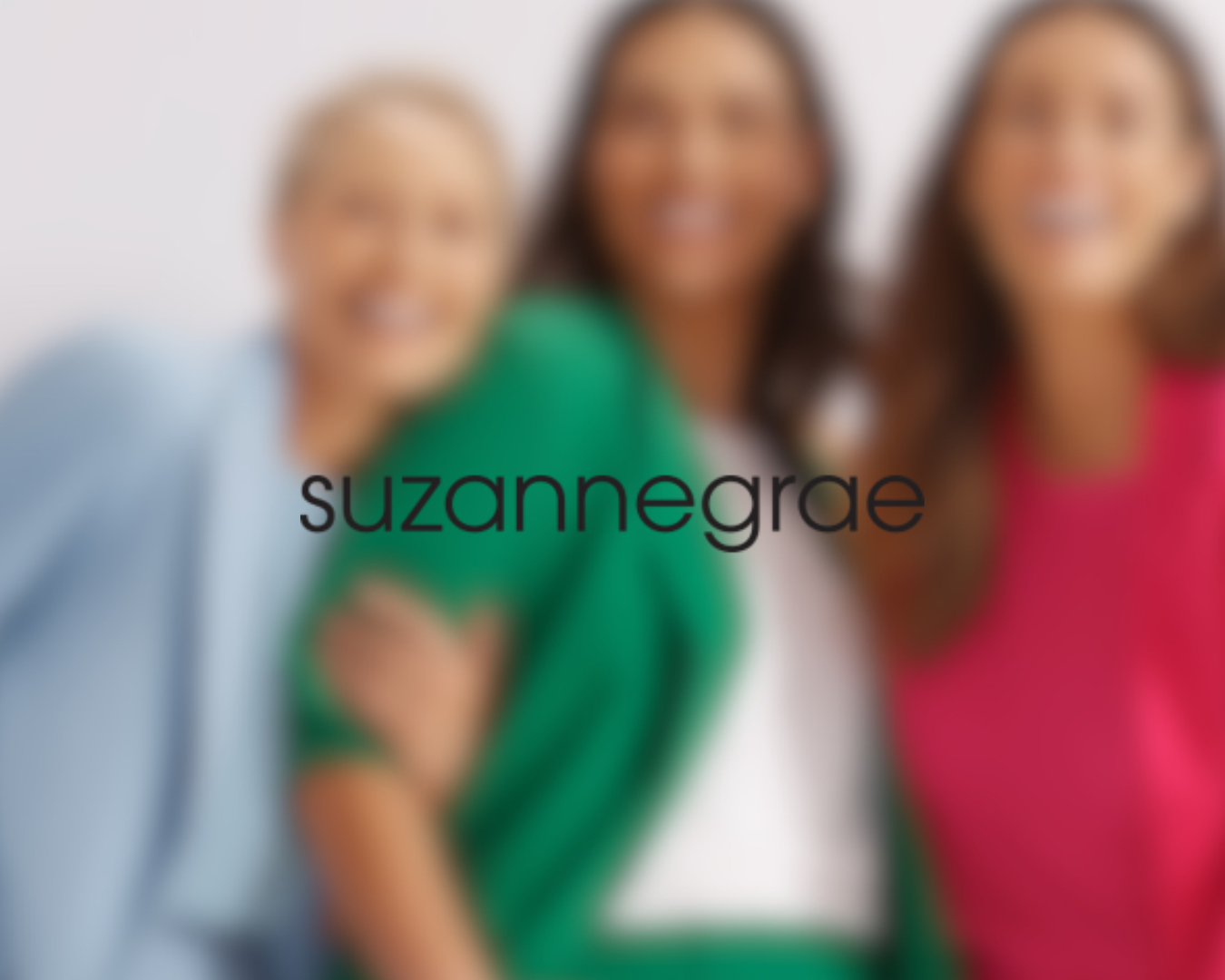 Blurred photo of four women smiling, wearing colorful tops, with the name 'suzanne grae' overlaid.