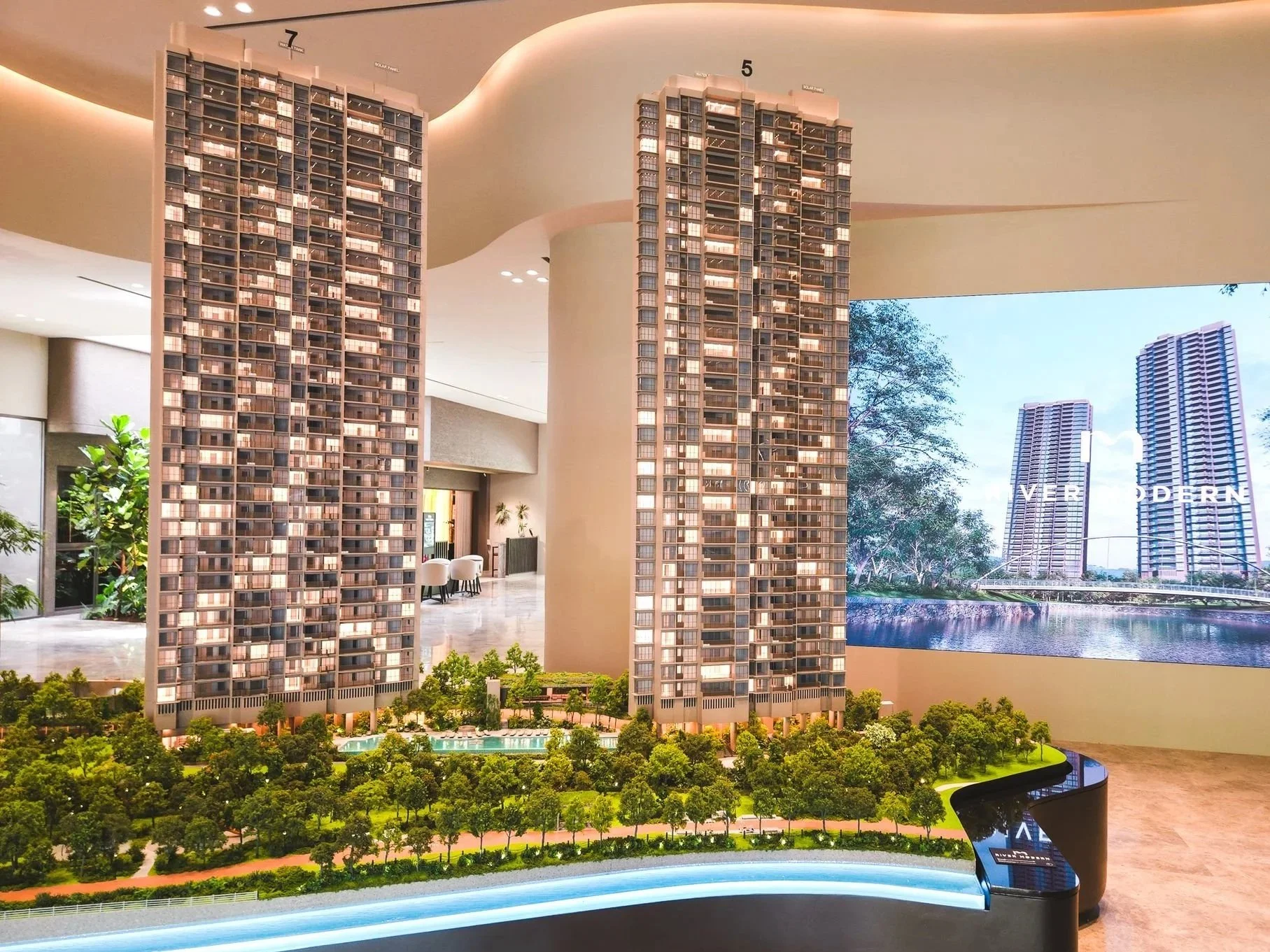 A detailed scale model of modern residential buildings and landscaped greenery, representing an urban development project.