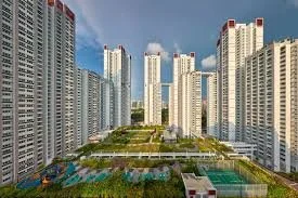 A cityscape with tall modern skyscrapers surrounding a large green park area with trees and pathways.