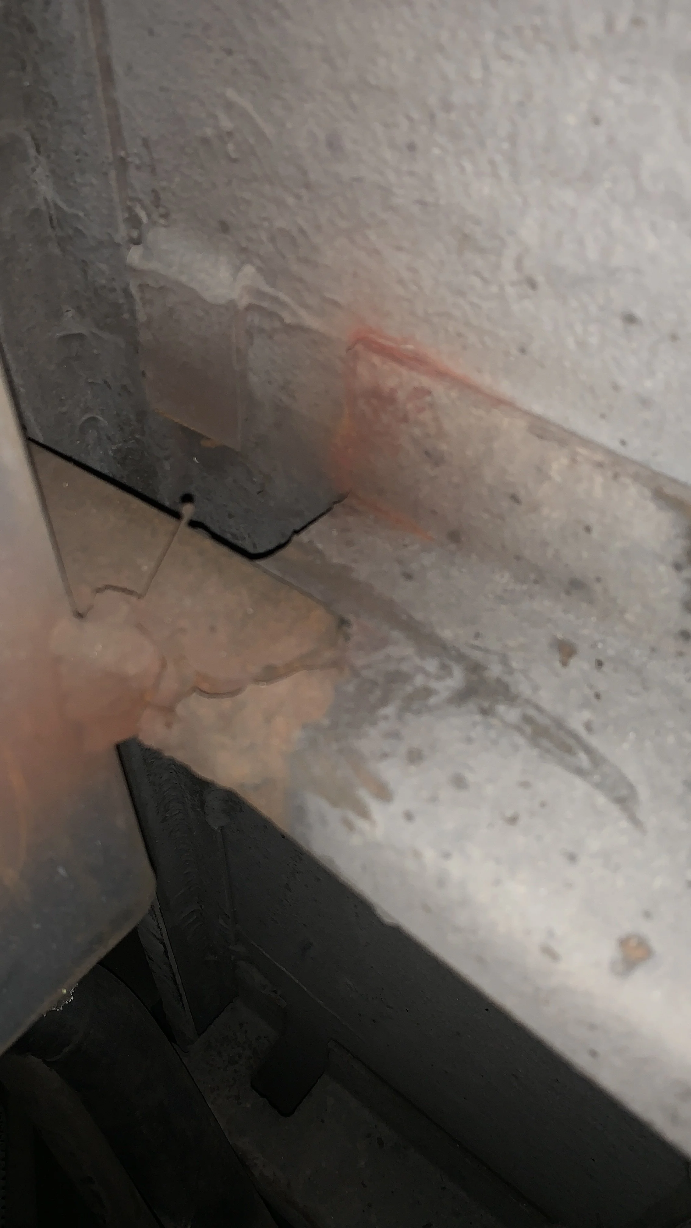 Close-up image of a metal surface with rust and corrosion, showing a rough texture and discoloration.