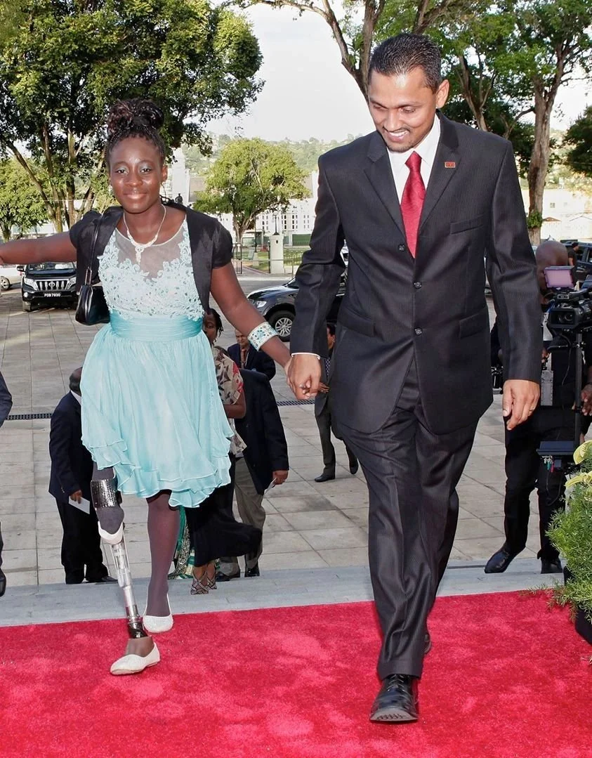 Dr. Inshan Meahjohn walking on a red carpet at the Global DPI Summit in Cape Town, South Africa