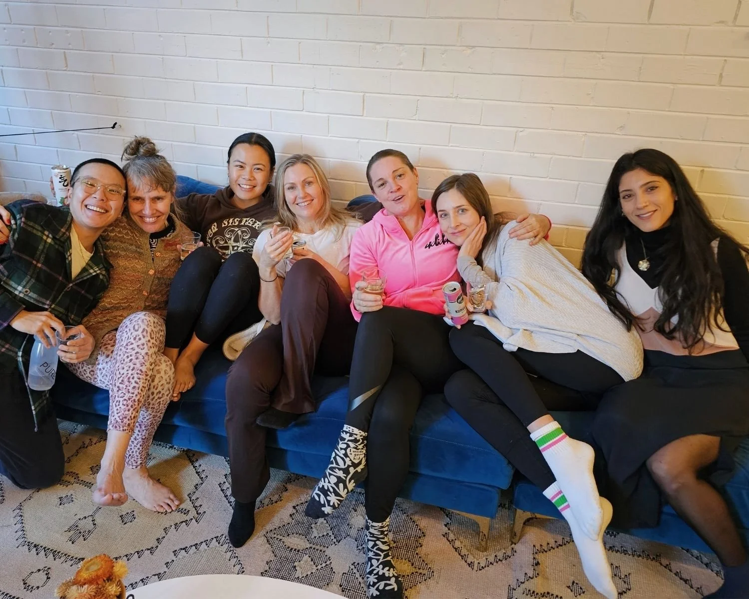 Members of the I Am That Studio community relaxing together in the studio reception in Collingwood, Melbourne