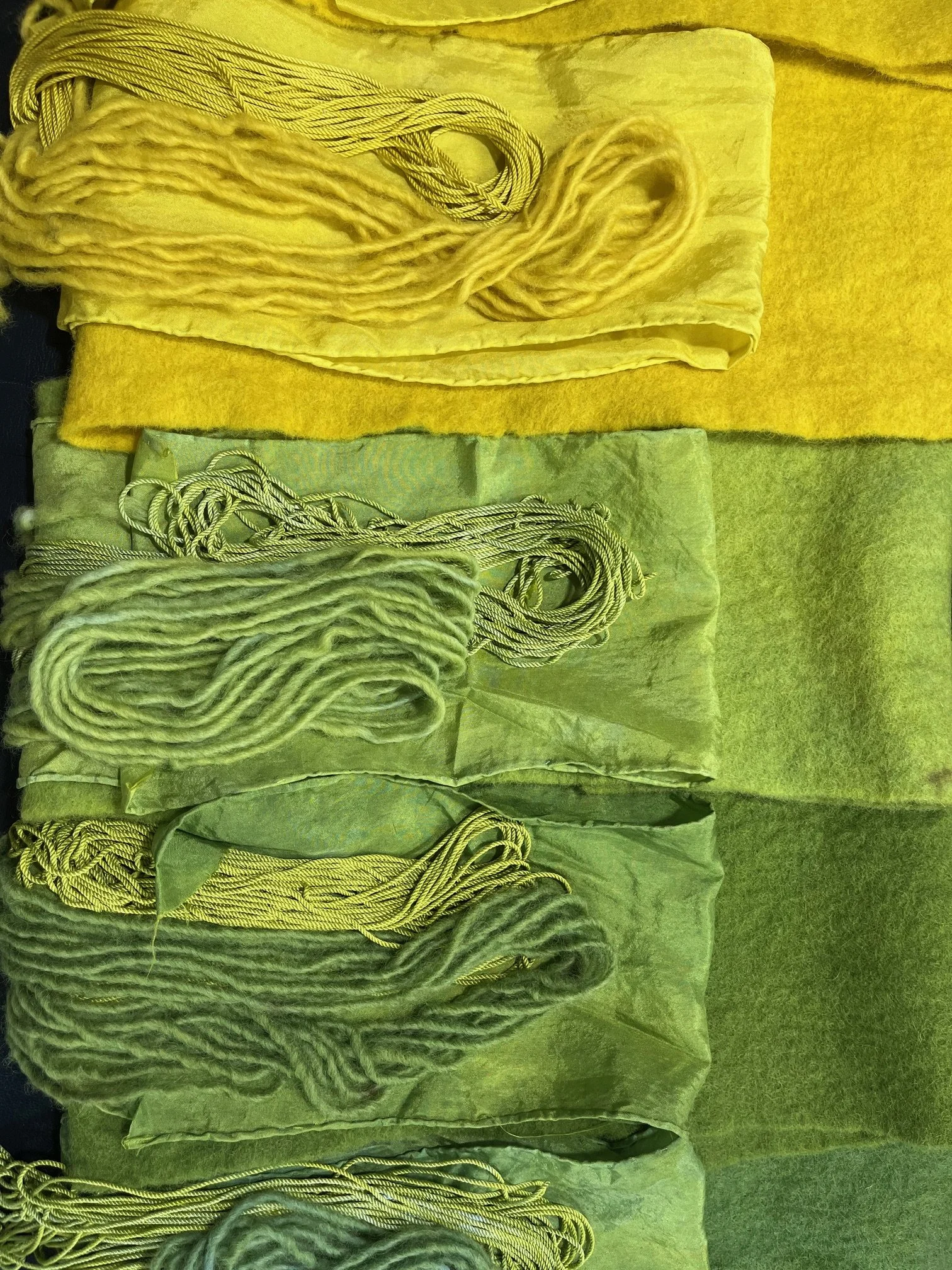 Yellow natural dyed textiles displaying soft to vibrant tones achieved through natural dye methods