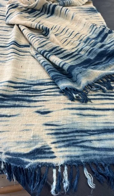 Handwoven Eri silk scarf from the Aya Signature Collection, dyed by Suzanne Connors using shibori and indigo techniques, revealing layered pattern and natural texture.