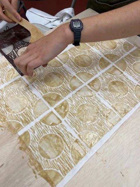 Hand application of rice paste resist for katazome stencil dyeing on fabric, traditional Japanese surface design process