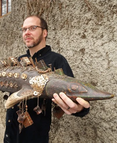 Daniel Essig, instructor of altered book arts, holding a mixed media sculptural book form