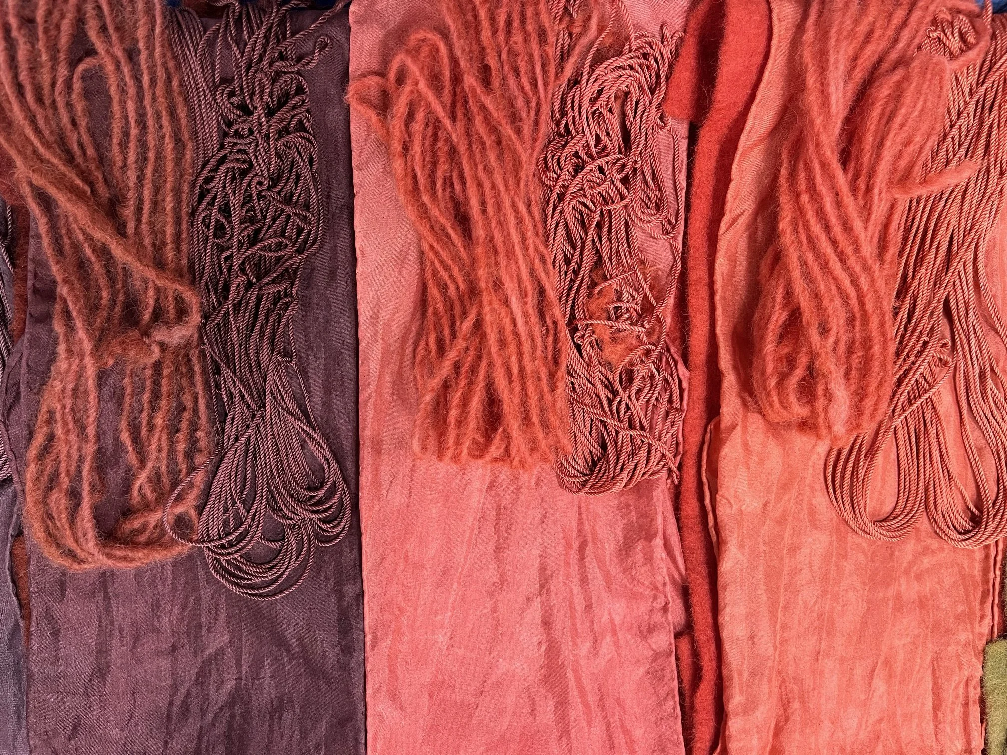 Natural dyed fabrics in red, rust, and terracotta tones showing variation from 18th century natural dye dye techniques