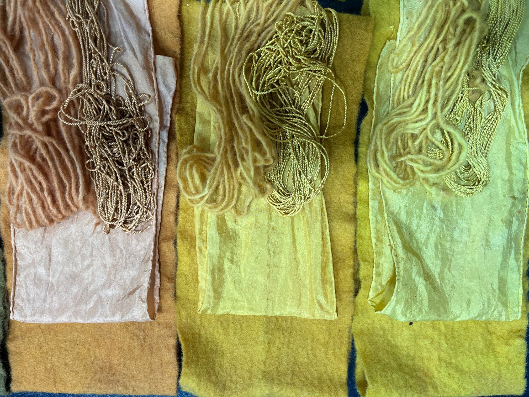 Yellow natural dyed textiles displaying soft to vibrant tones achieved through natural dyeing methods