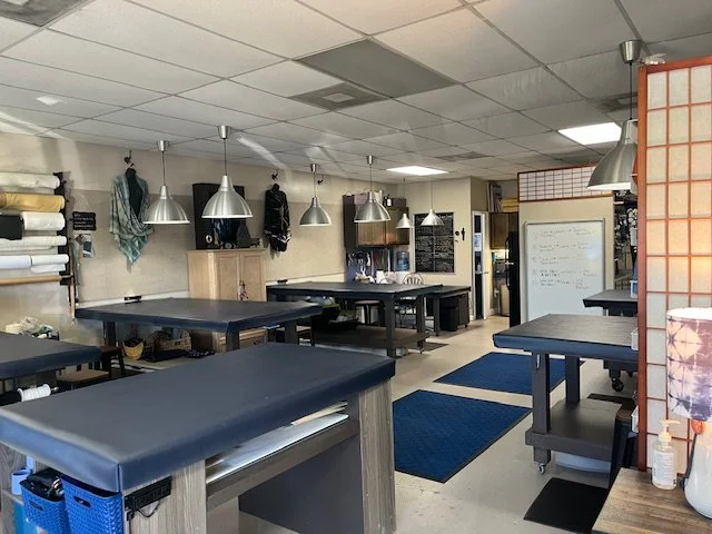 The aya fiber Studio workspace featuring large worktables
