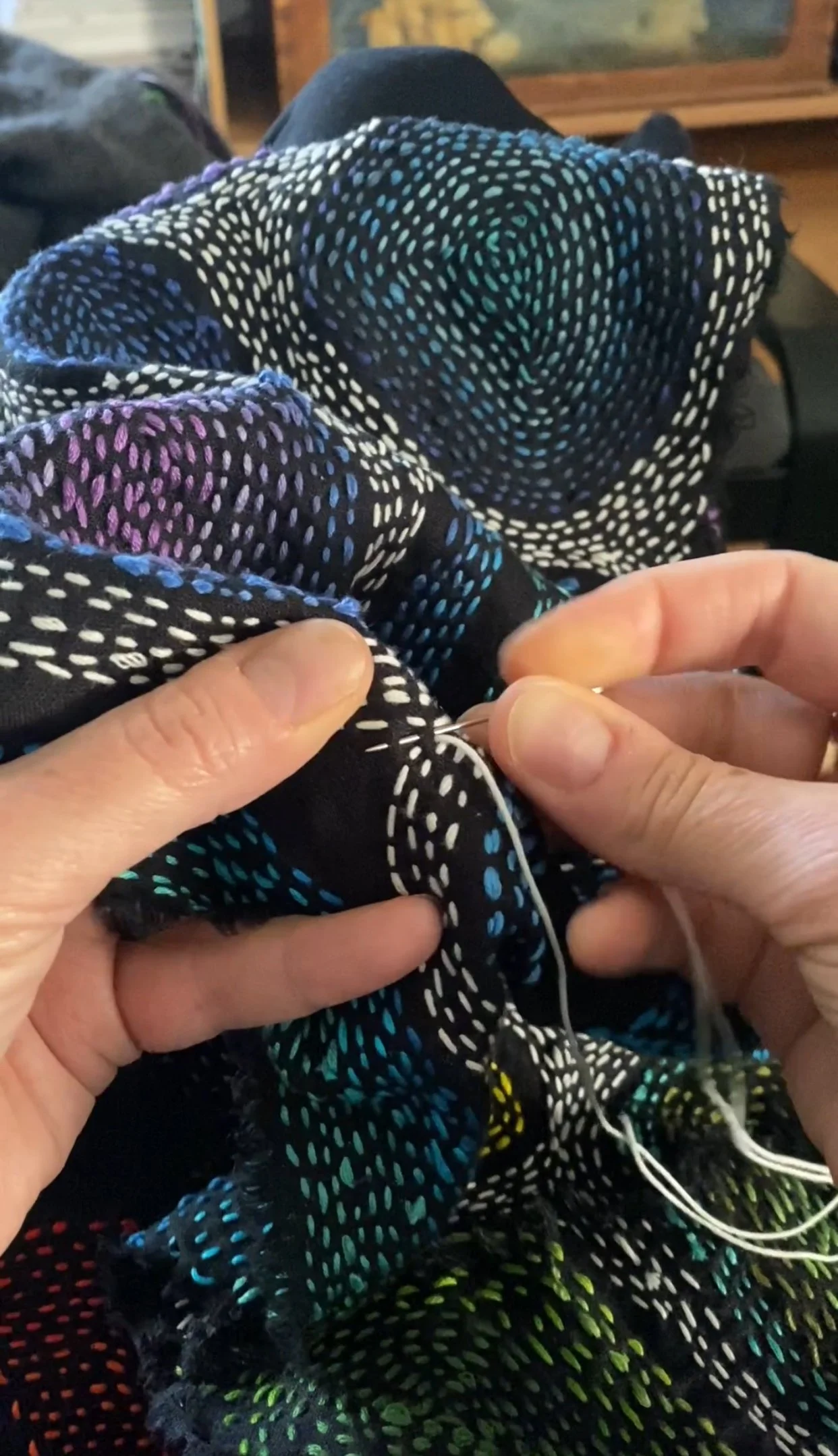Judy handstitching a scarf