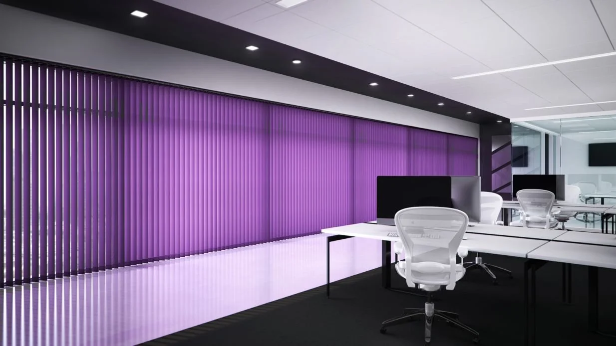 Modern office with white desks, white chairs, black monitors, purple vertical blinds, and a glass wall.