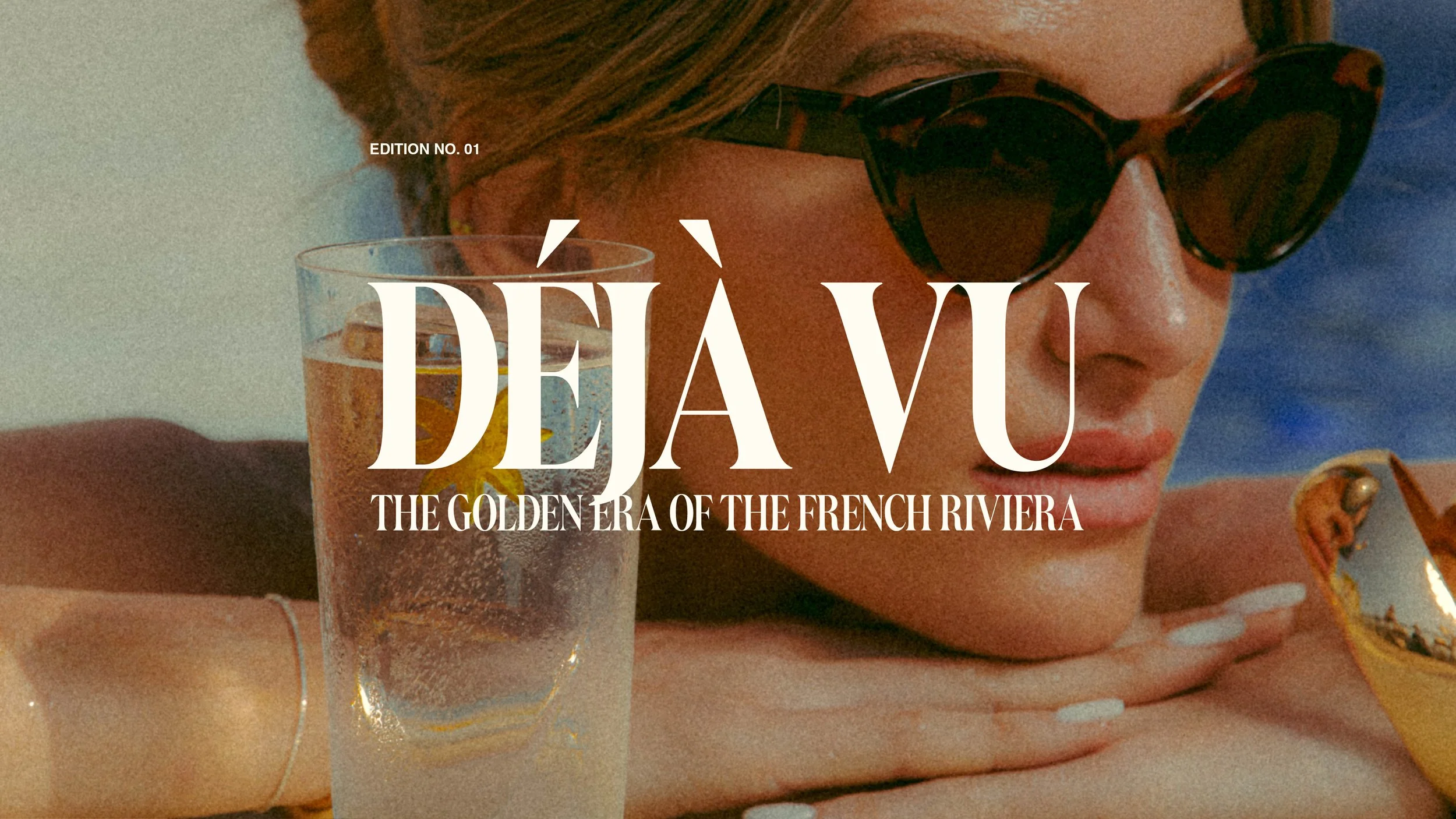 A woman with sunglasses relaxing by the French Riviera with a drink close by.