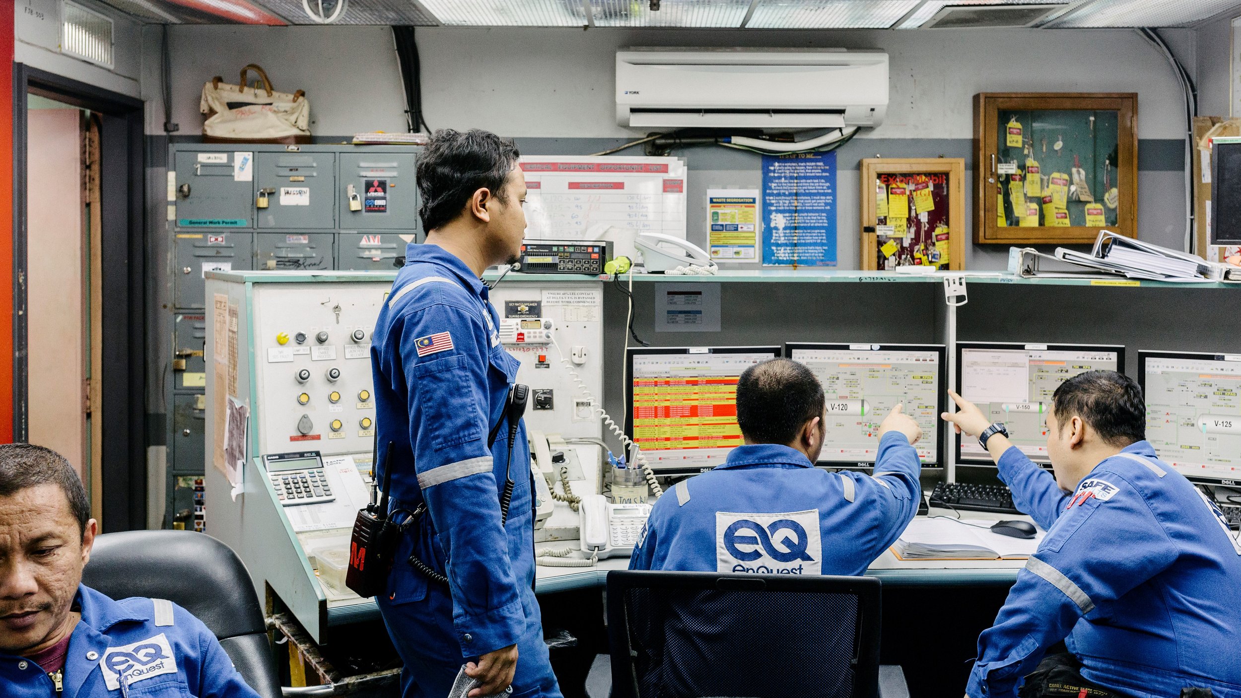Four workers in blue uniforms with