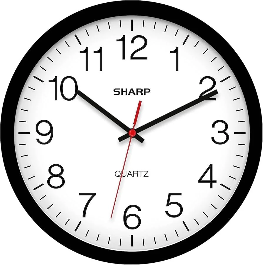 Round wall clock with black frame, white face, black hour and minute hands, red second hand, and black numbers from 1 to 12. The clock shows the time as 10:10:32. Save time by using an academic editing service
