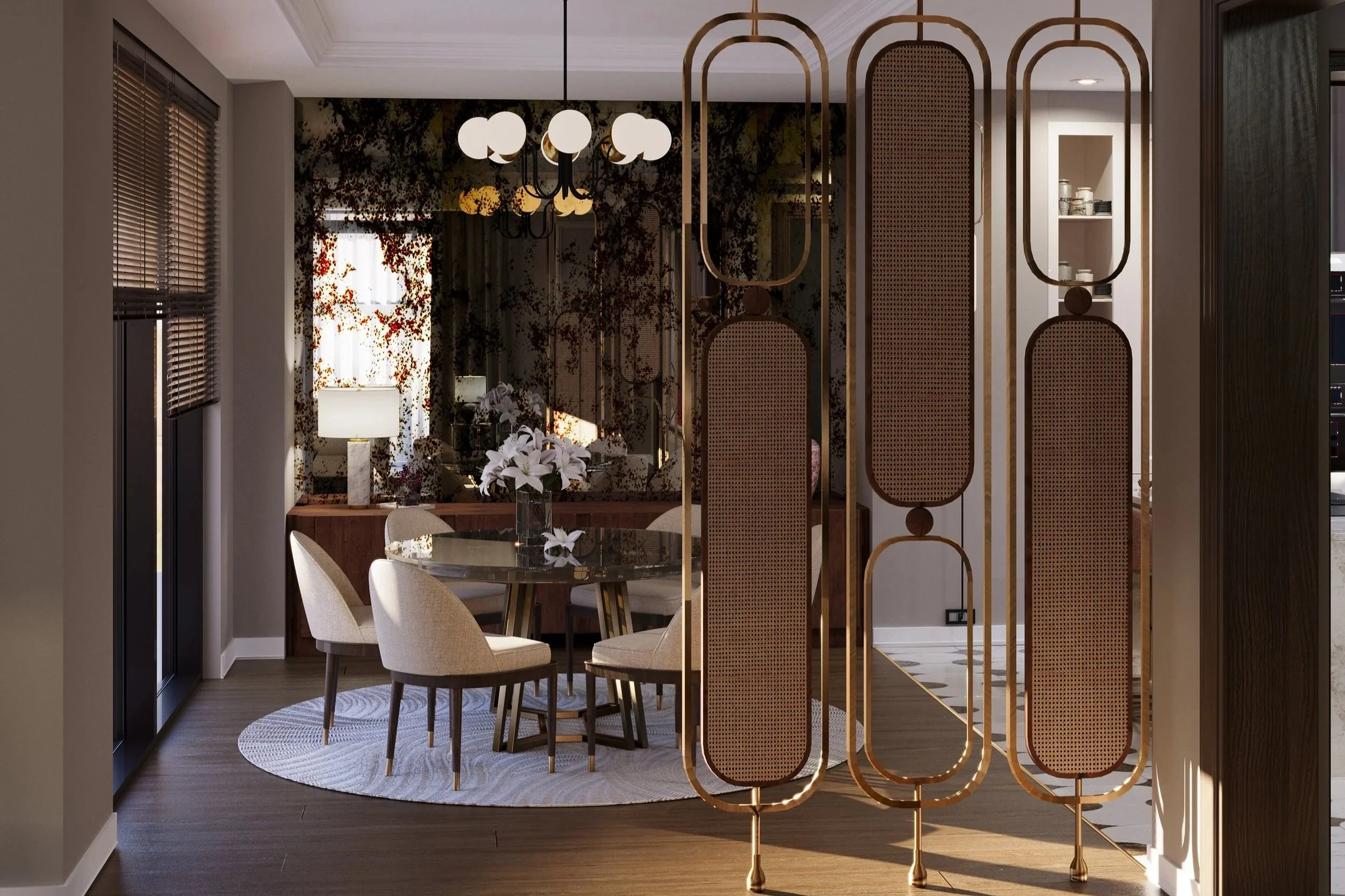 A modern dining area with a glass table, six beige upholstered chairs, and a floral centerpiece. There's a decorative gold room divider with oval shapes in the foreground. Behind the table, a sideboard with a lamp and flowers, and a large mirror reflecting a window with floral curtains. The room has wooden floors, a round rug, and a black chandelier with globe lights.