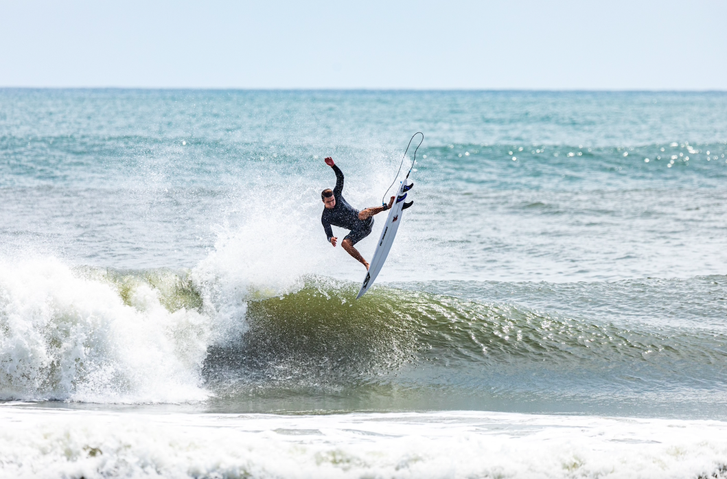 A person surfing on a wave in the ocean.
