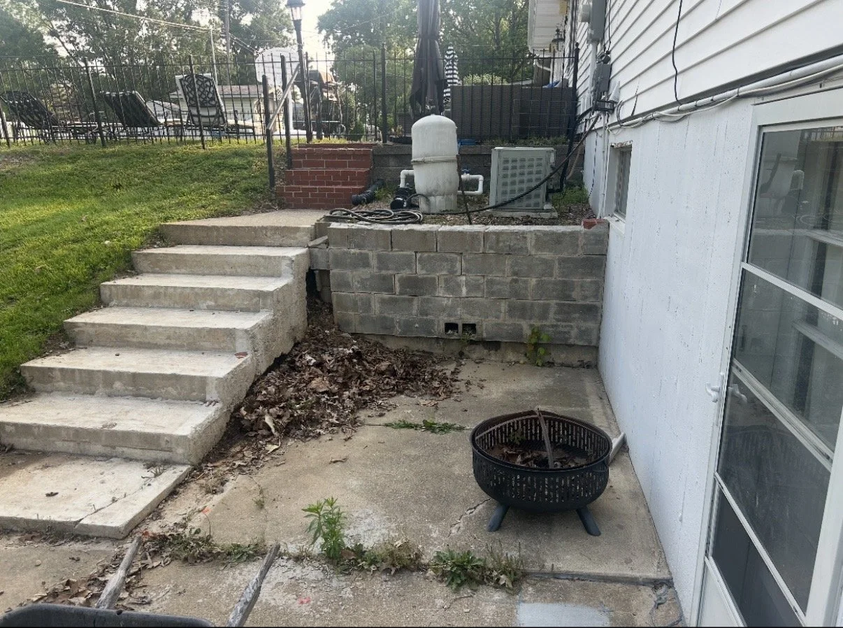 Before picture of a back yard that needs a failing retaining wall fixed.