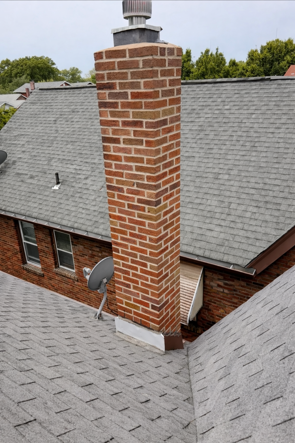 After picture of a tuckpointed brick chimney.