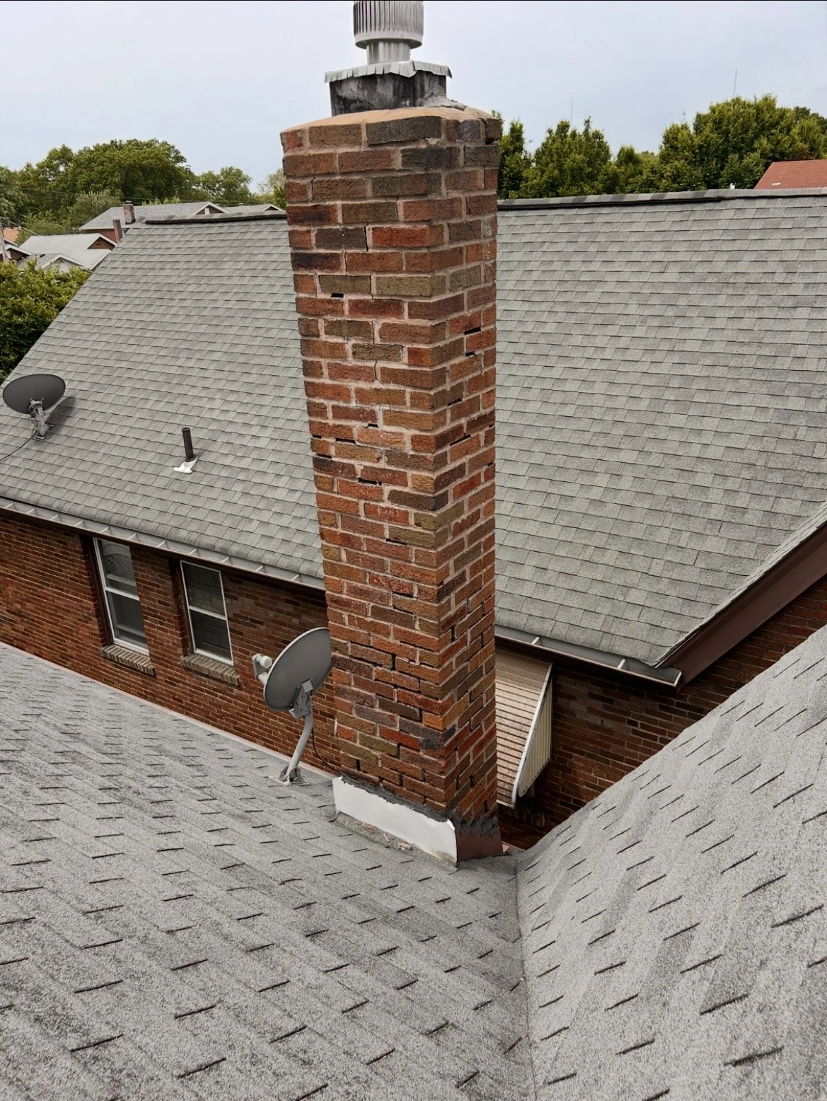 Before picture of a brick chimney repair with missing mortar.