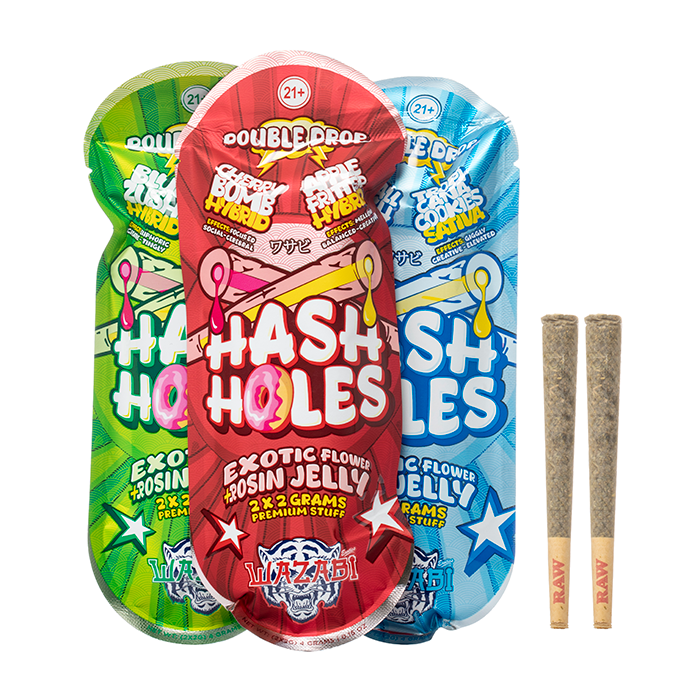 Three colorful bags of Hash Holes cannabis-infused snacks in green, red, and blue packaging, alongside two pre-rolled cannabis joints.