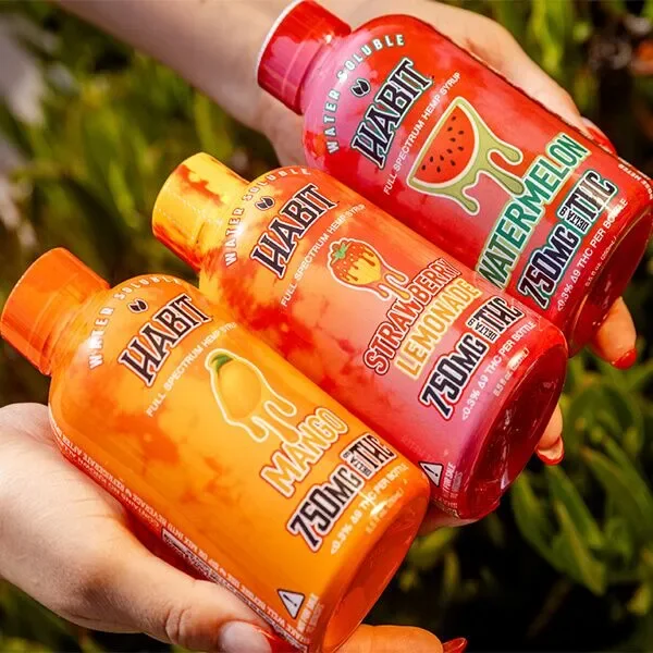 Three bottles of HABIT water flavoring, each with different flavors: mango, strawberry lemonade, and watermelon.