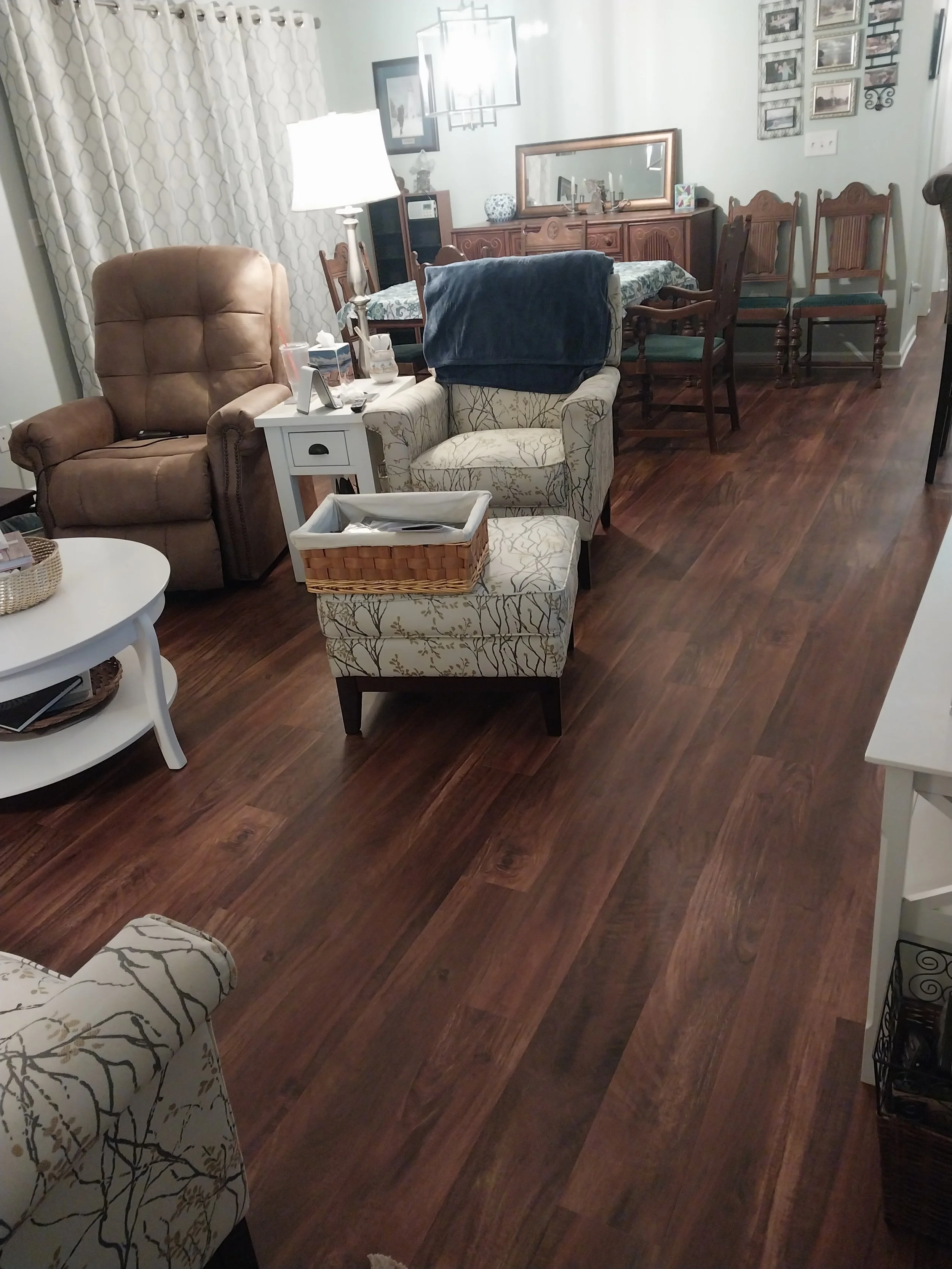 Living room and dinning room space in a condominium with vinyl wood look planks